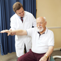 doctor assisting old man